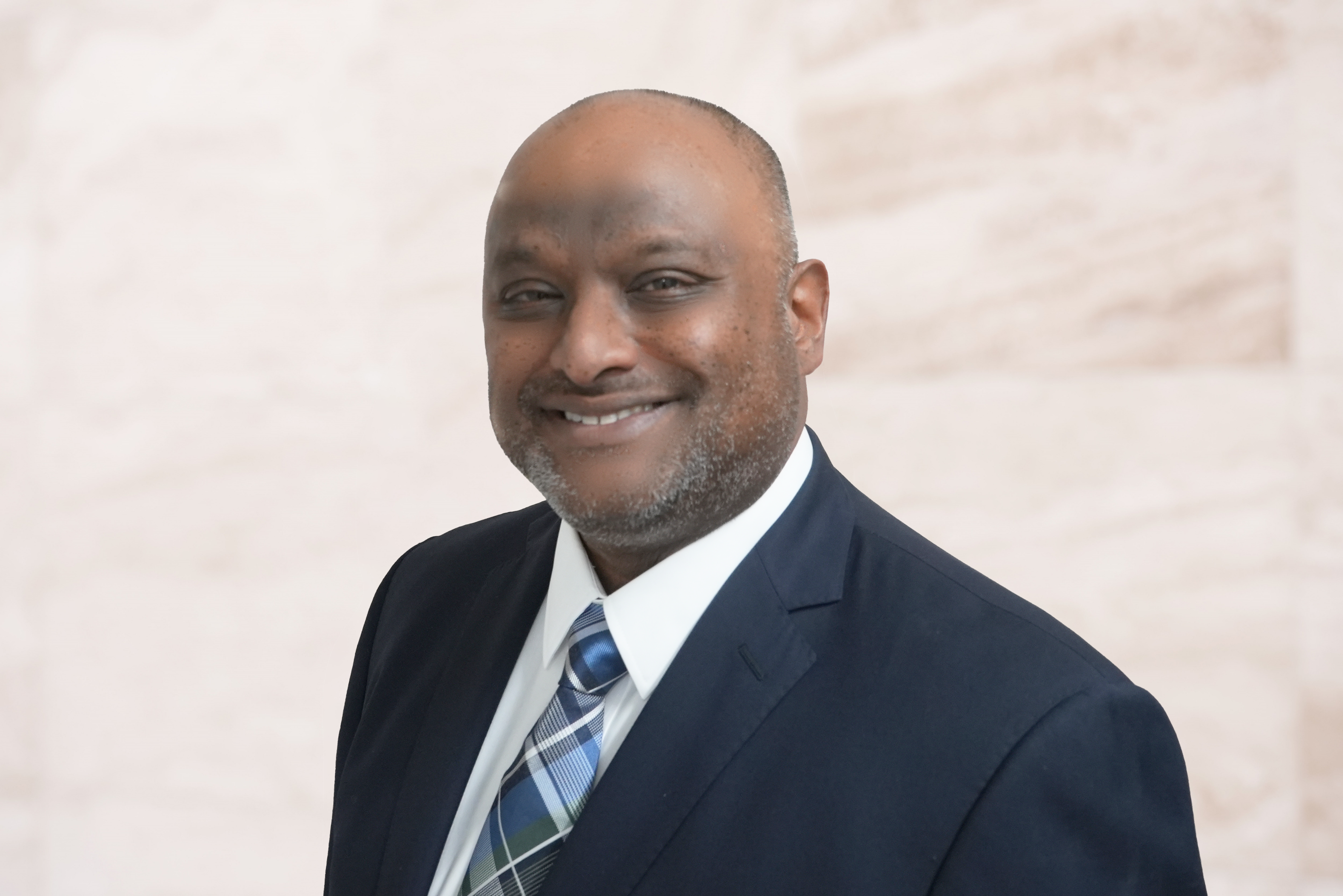 Melvin Thathiah, attorney at The Law Office of Bryan Fagan, smiling in professional attire against a neutral background.