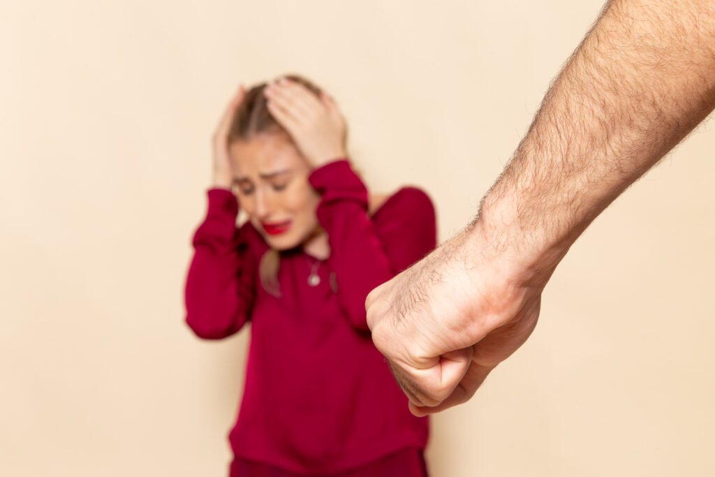 top strategies for defending against assault accusations, front view young female red shirt suffers from physical violence cream space female cloth photo