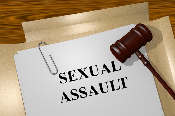 Sexual assault document with gavel and paper clip, representing legal concepts related to consent laws in Texas.