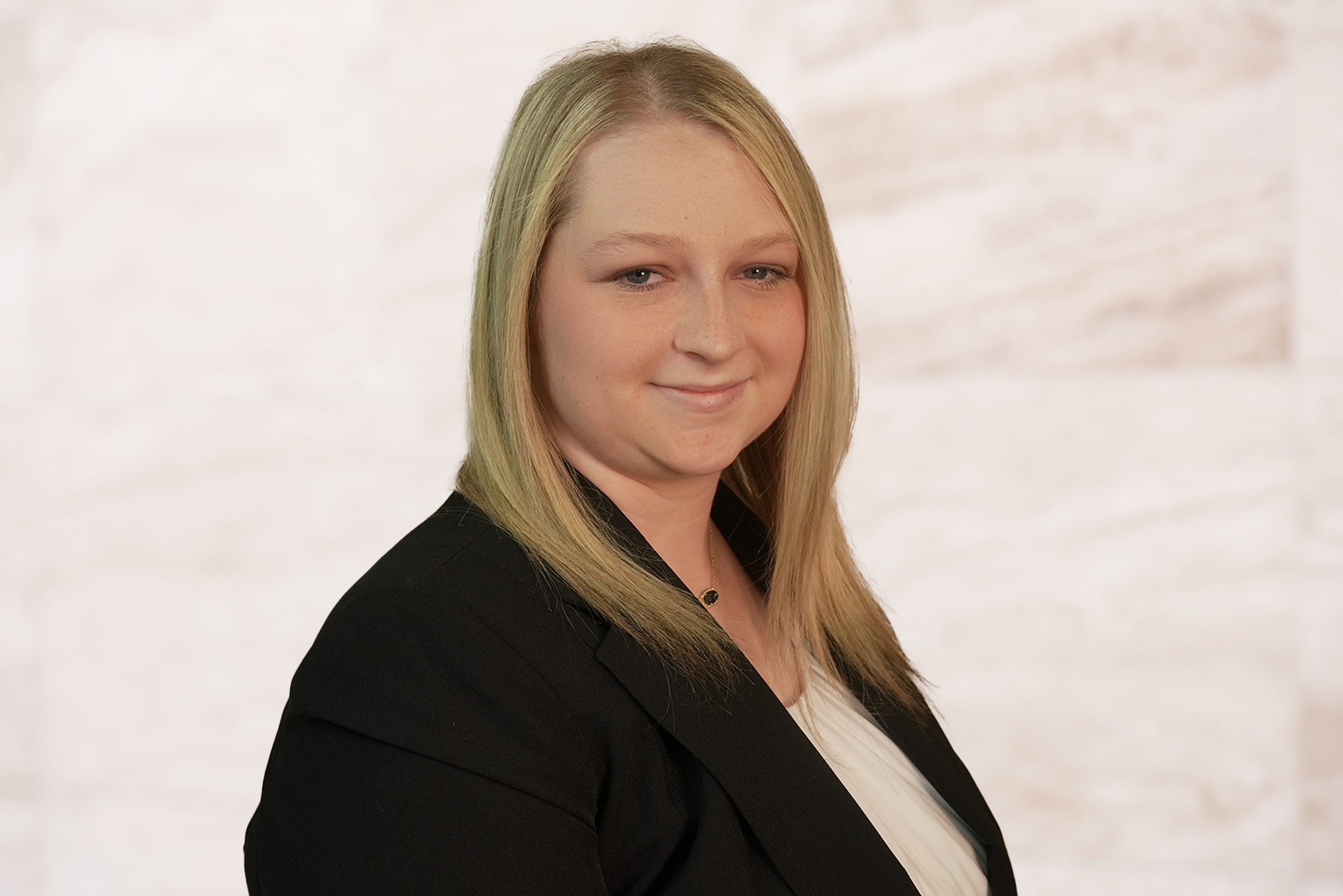 Chelsea C. Wojcik, attorney at the Law Office of Bryan Fagan, in professional attire, smiling against a neutral background, representing expertise in family law.