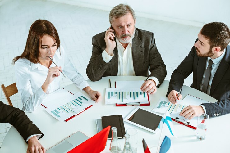 when a person passes away, the process of managing their estate falls to an executor if one is named in the will, business people working together