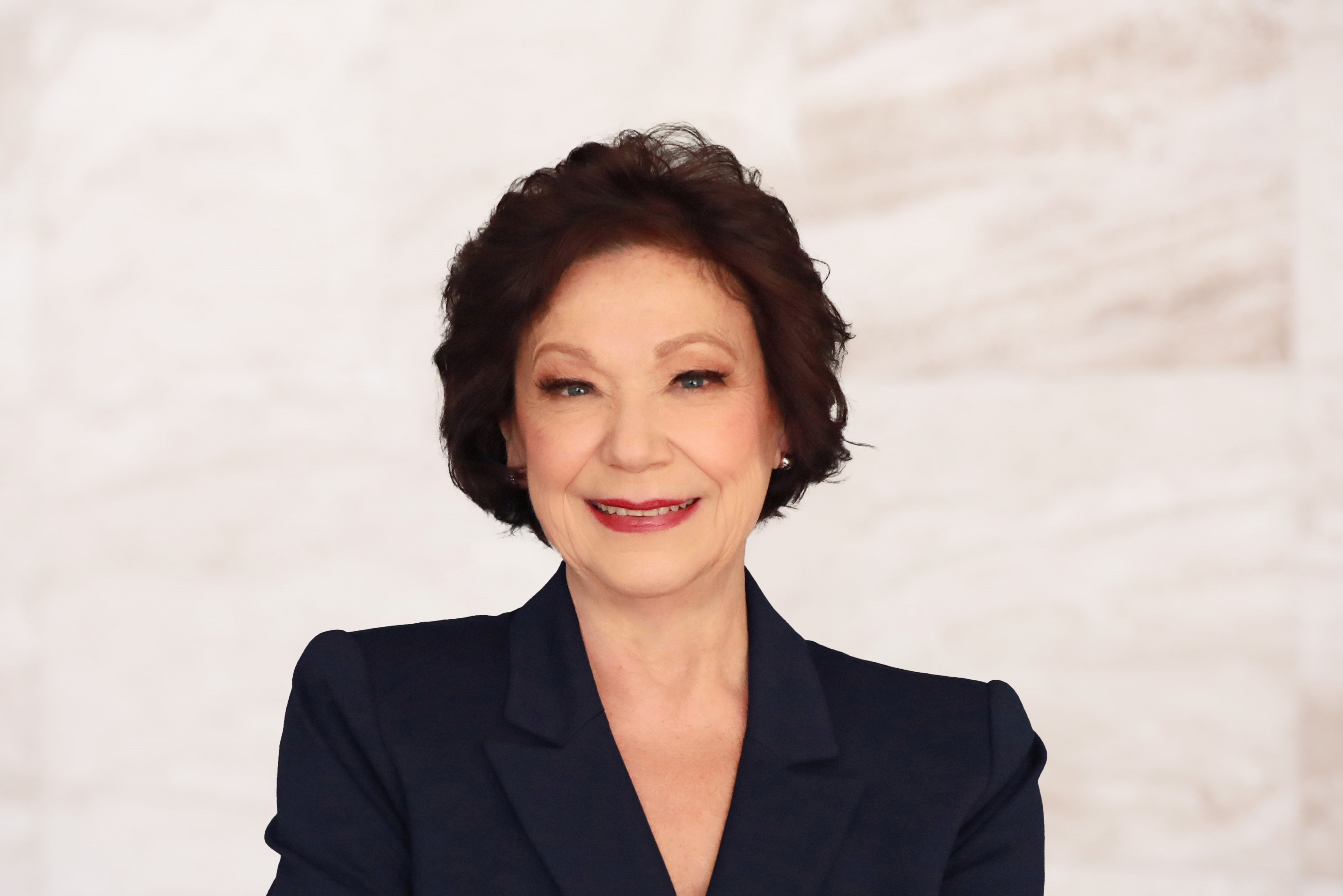 Diana Weitzel, attorney at Law Office of Bryan Fagan, PLLC, smiling in professional attire against a neutral background, representing her commitment to legal services and community involvement in Texas.