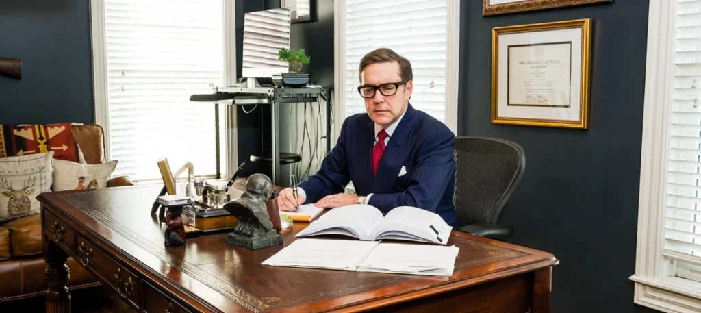 Attorney at desk reviewing legal documents in a professional office setting, emphasizing expertise in sexual assault defense.